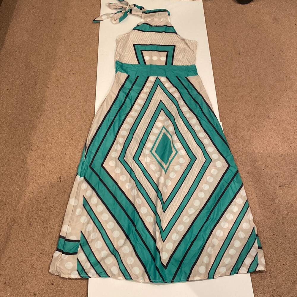 Maxi dress. Ties at the side of the neck.  Material does not have any give.